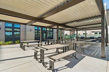 Covered outdoor dining area with picnic tables
